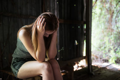 Midsection of woman sitting at home