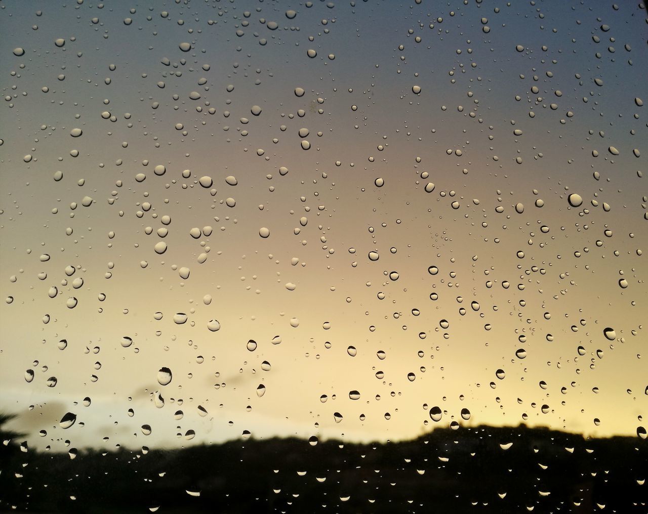 wet, drop, water, sky, rain, glass - material, no people, window, transparent, nature, full frame, sunset, backgrounds, raindrop, close-up, indoors, focus on foreground, rainy season, glass