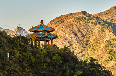 View of cross on mountain against sky