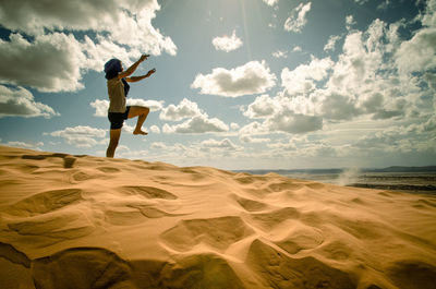 Man in the desert, happy and jumps, jumping in the desert celebrating her freedom