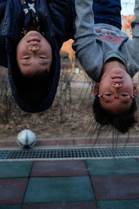 Upside down view of siblings at outdoors