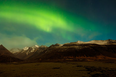 Scenic view of snowcapped mountains against sky at night