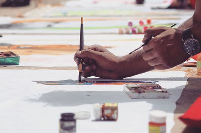 Close-up of the hands of a male artist drawing