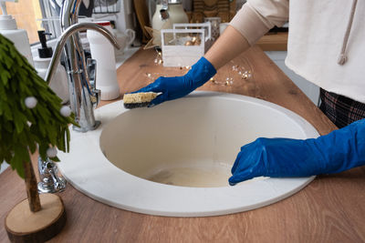 High angle view of man washing hands in bathroom