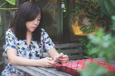 Young woman using mobile phone outdoors