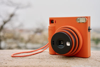 Vintage orange instant camera. travel shooting equipment