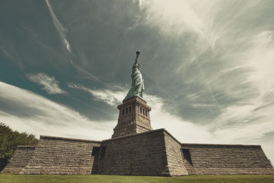 Low angle view of statue against cloudy sky