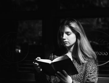 Young woman reading book