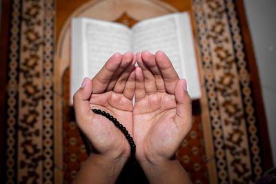 Close-up of woman hand holding cross