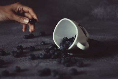 Close-up of spilled berries and cup