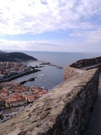 Scenic view of sea by city against sky