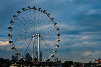 Low angle view of ferris wheel against sky