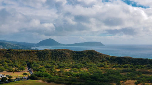 Scenic view of sea and mountains against sky