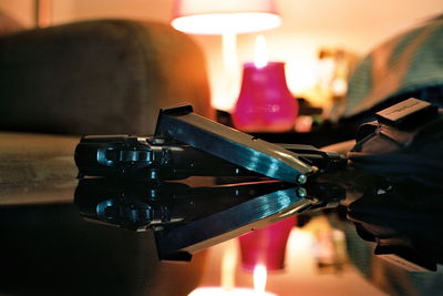 Close-up of illuminated lamp on table