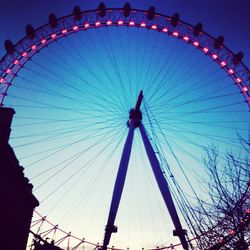 Low angle view of ferris wheel against sky