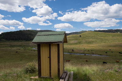 Built structure on field against sky