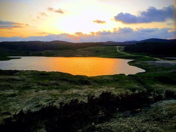 Scenic view of lake against sky during sunset