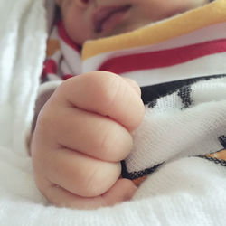 Close-up of baby sleeping on bed