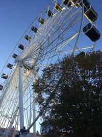 Low angle view of ferris wheel against sky