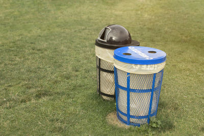 High angle view of garbage bin on field