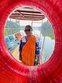 Portrait of young woman standing against mountain