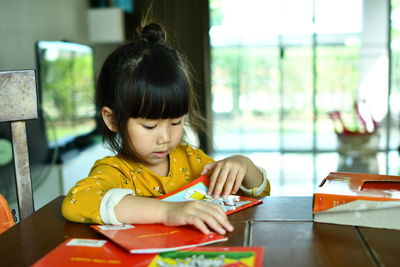 Girl sitting on table