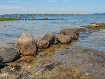 Rocks on beach against sky