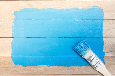 High angle view of blue paint on table