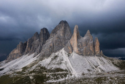 Drei zinnen in the dolomites mountains with upcoming thunderstorm above.