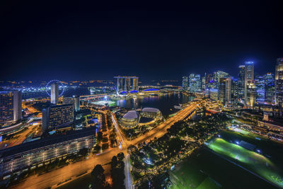 High angle view of illuminated buildings in city at night