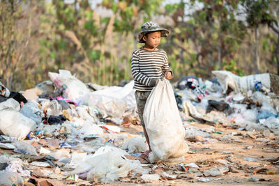 Full length of man standing on garbage