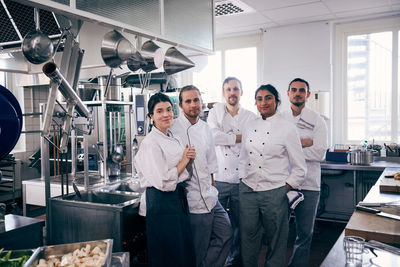 Portrait of chefs standing together in commercial kitchen