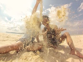 View of people swimming in sea against sky