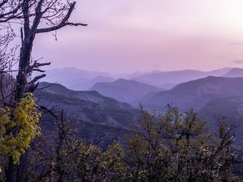 Scenic view of mountains against sky at dusk