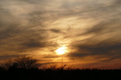 Silhouette of landscape against cloudy sky