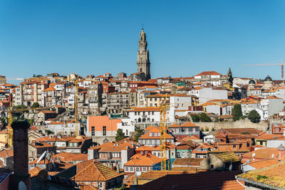 Buildings in town against clear sky