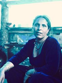 Portrait of young woman sitting outdoors