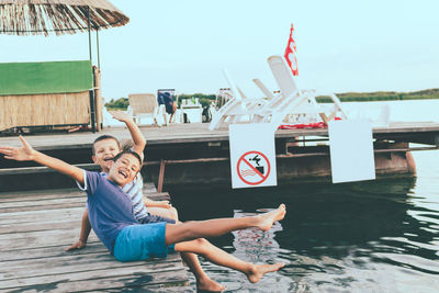 Carefree kids having fun on a pier during summer vacation.