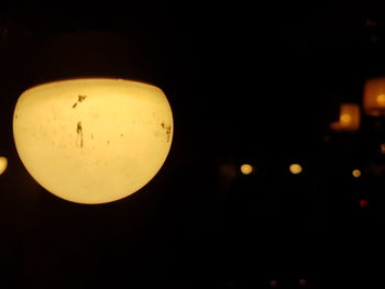 Low angle view of illuminated lights at night