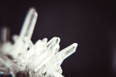 Close-up of snow on metal against black background