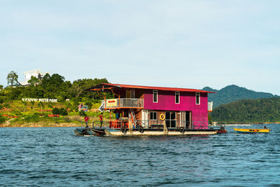 Built structure by sea against sky