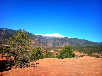 Scenic view of mountains against blue sky