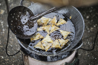 High angle view of samosa frying in wok