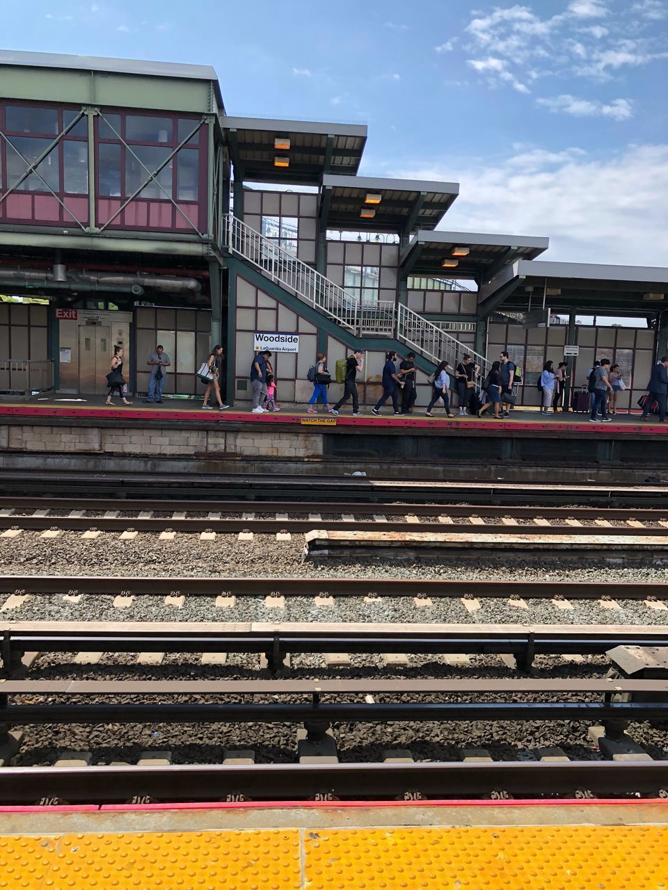 PEOPLE ON RAILROAD STATION PLATFORM