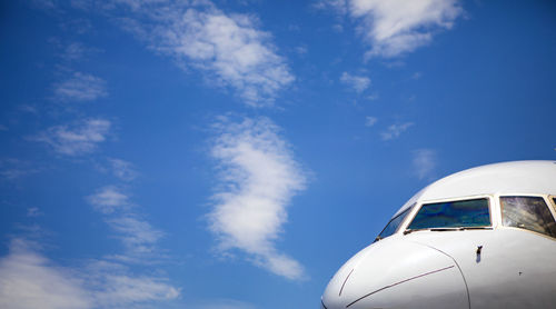 Cockpit of jet airliner with blue skies