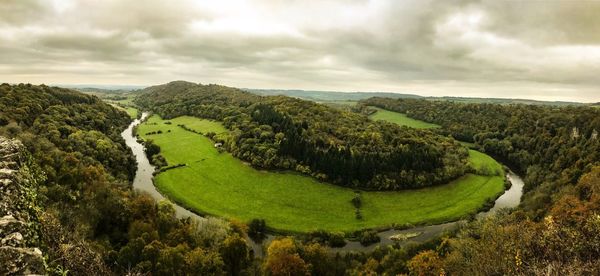 Scenic view of green landscape against sky