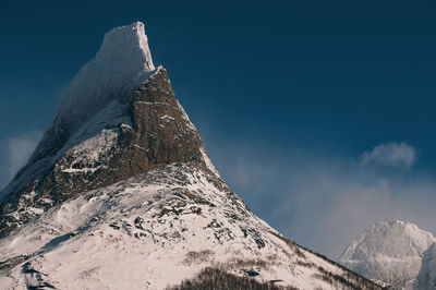 Low angle view of snowcapped mountain against sky