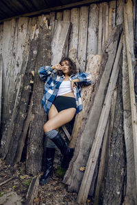 Young woman sitting on wood