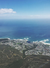 High angle view of townscape by sea against sky