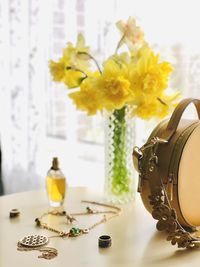 Close-up of yellow flower vase on table